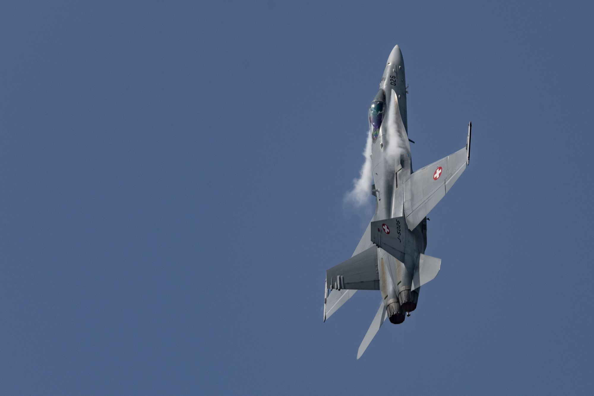 F/A-18 Hornet of Swiss Airforce with lateral chemtrails of Dihydrogenmonoxide