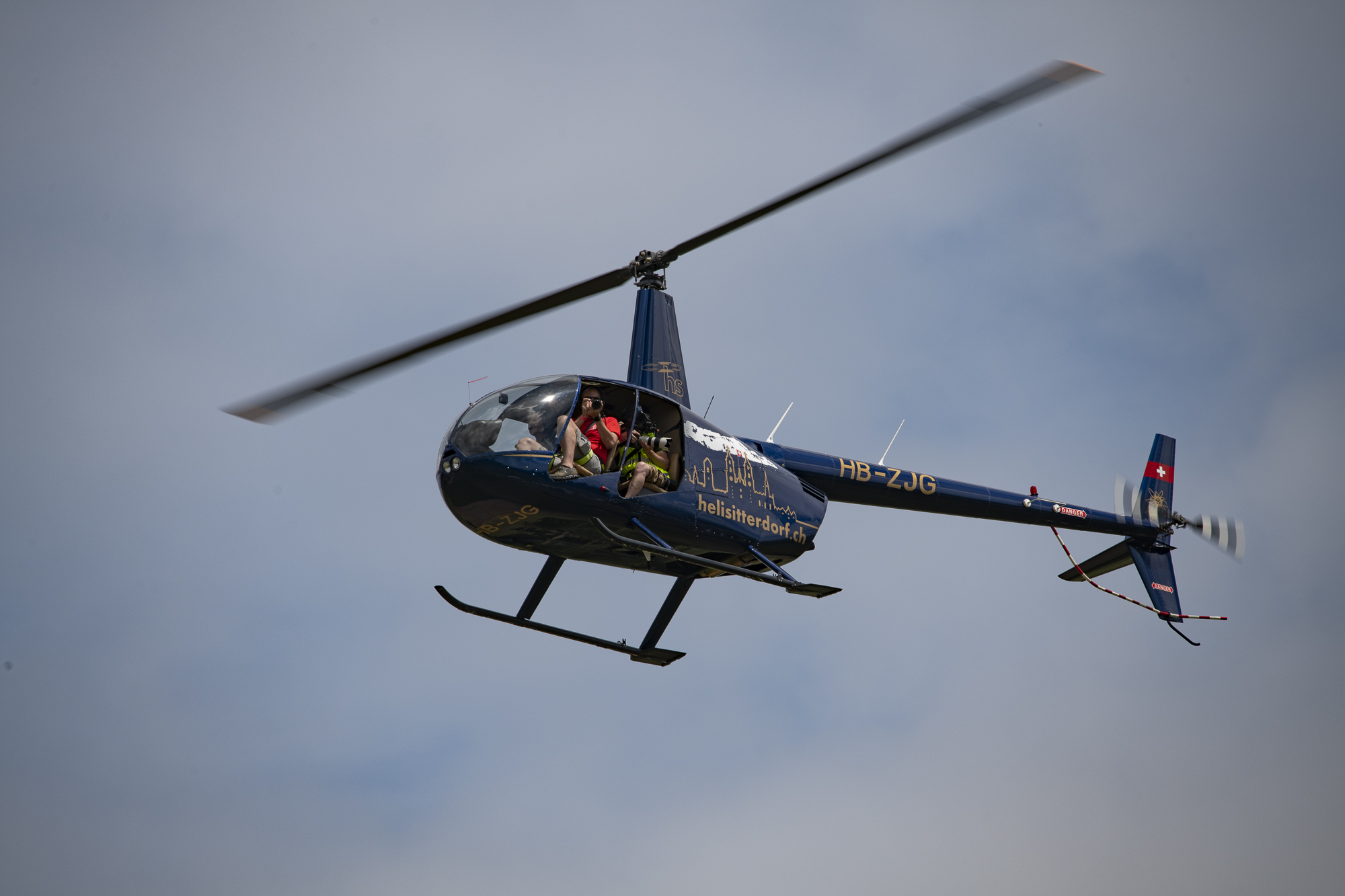 Robinson R44 Raven II Helicopter with photographers on board
