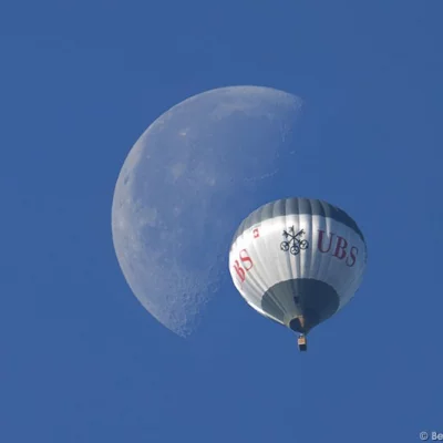 Balloon crossing moon
