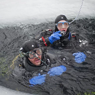Two divers in an Icehole